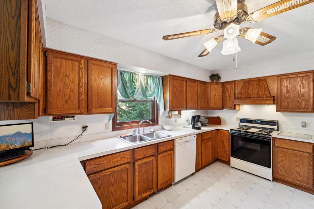 Functional kitchen layout with extensive cabinet storage, updated countertops, and plenty of prep space for everyday living and entertaining.