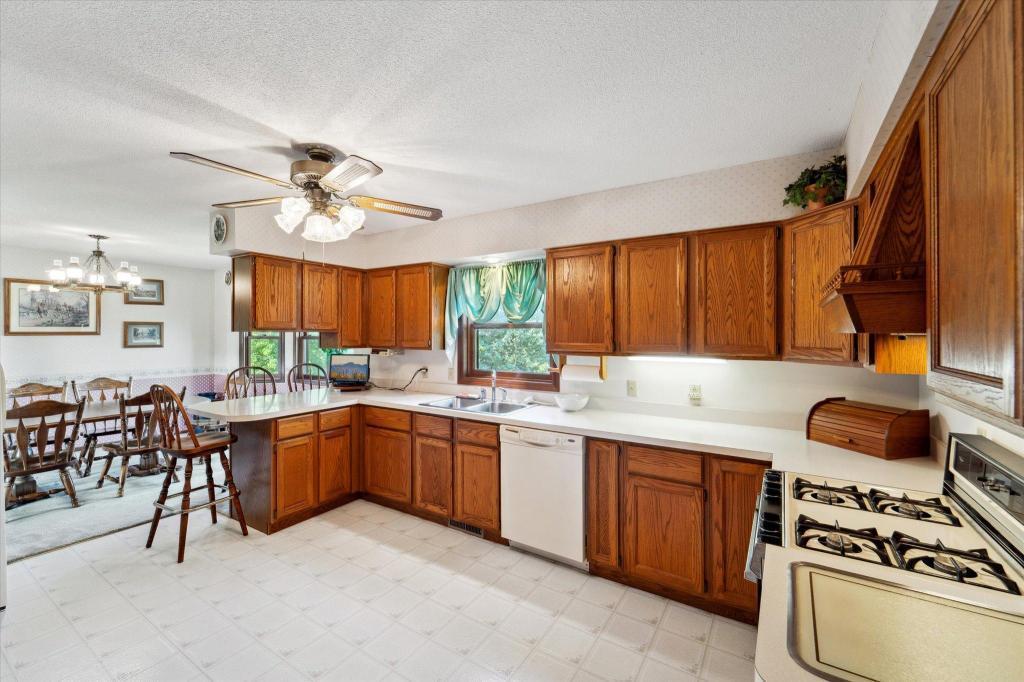 Bright and inviting kitchen with breakfast seating, ample cabinetry, and easy flow into the dining area.