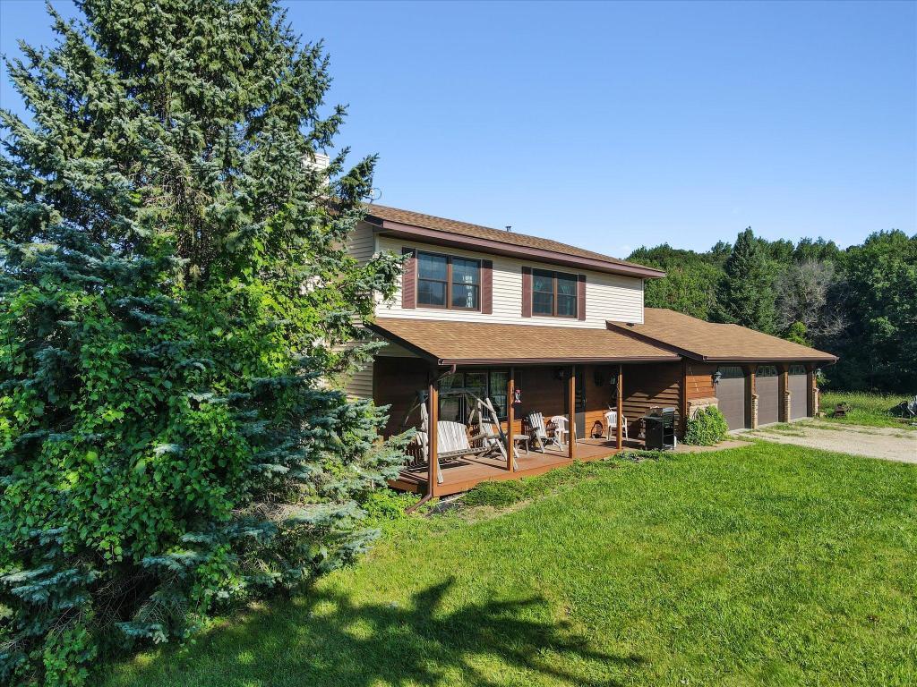 Peaceful country setting surrounded by mature trees with a welcoming covered front porch and plenty of room to relax and enjoy the views.