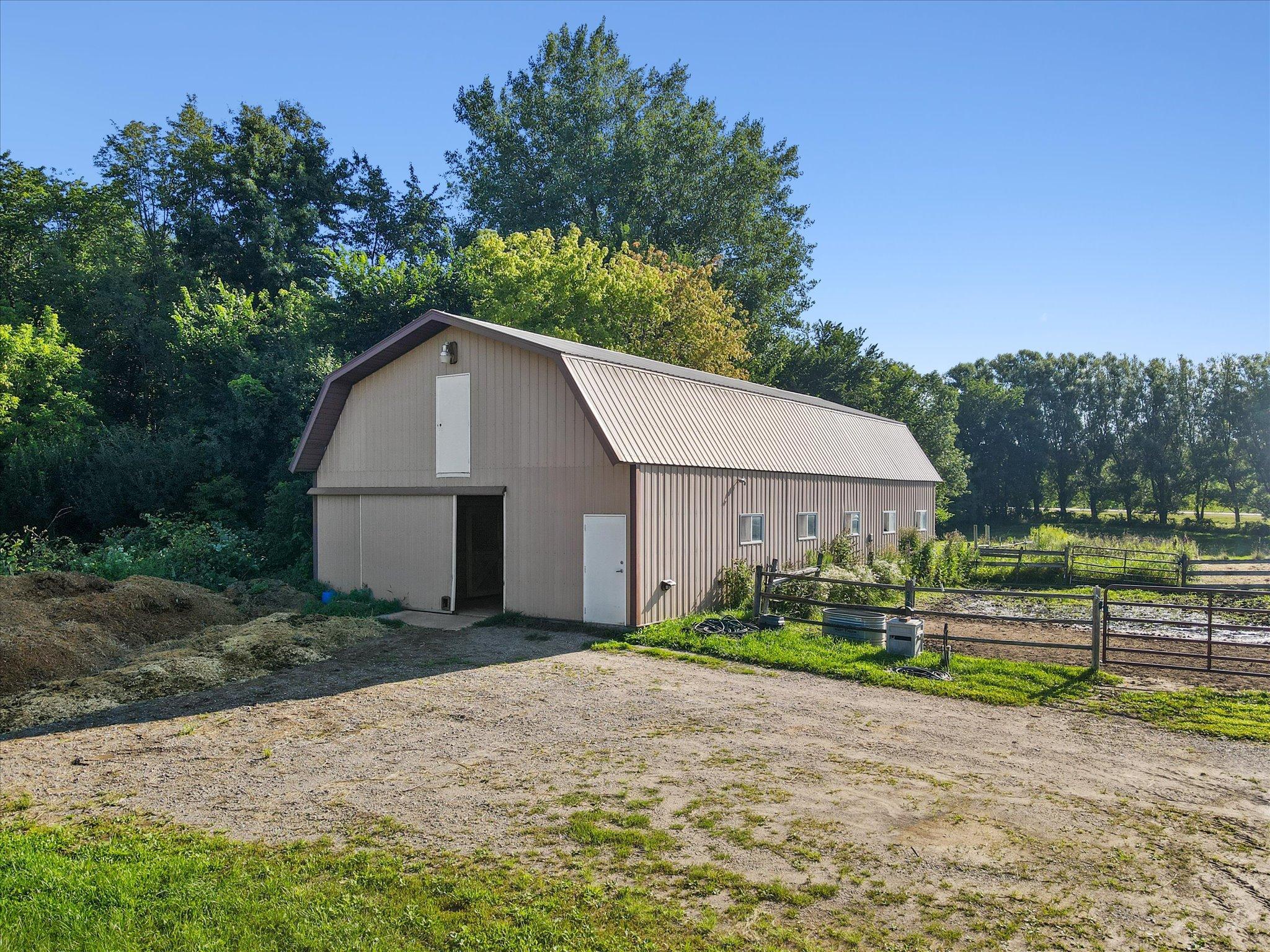 Impressive outbuilding with ample storage, workshop potential, and excellent setup for hobby farm or equestrian use.