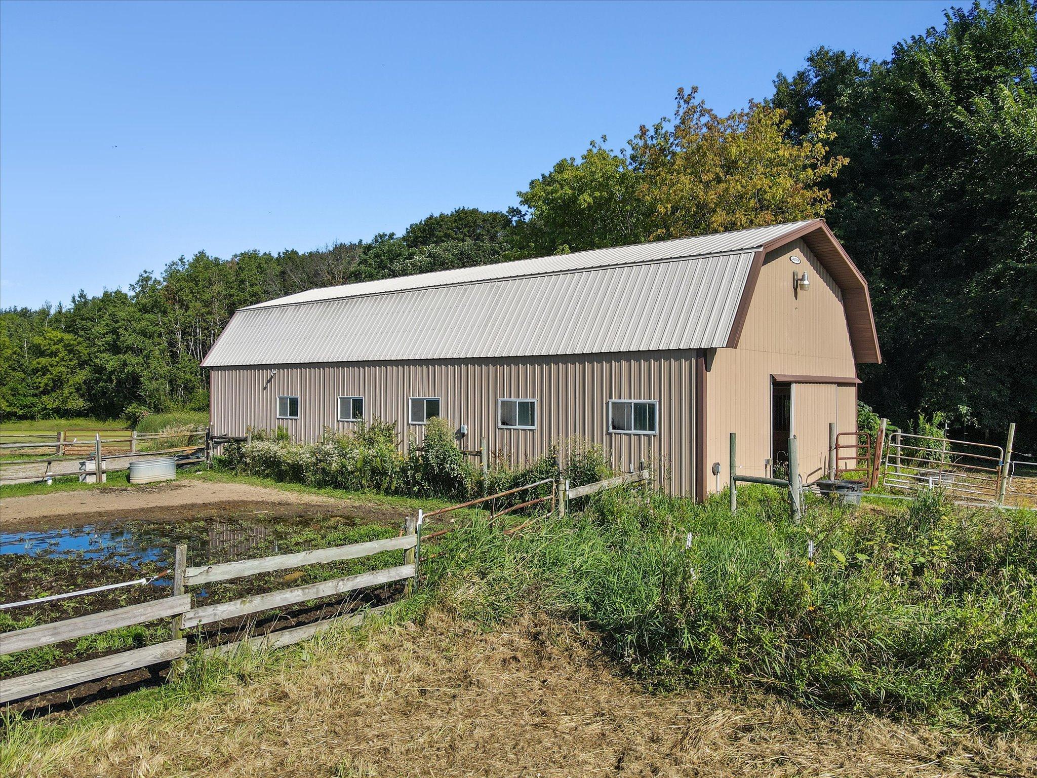 Large barn and fenced pasture areas ready for horses, livestock, equipment storage, or additional hobby space.