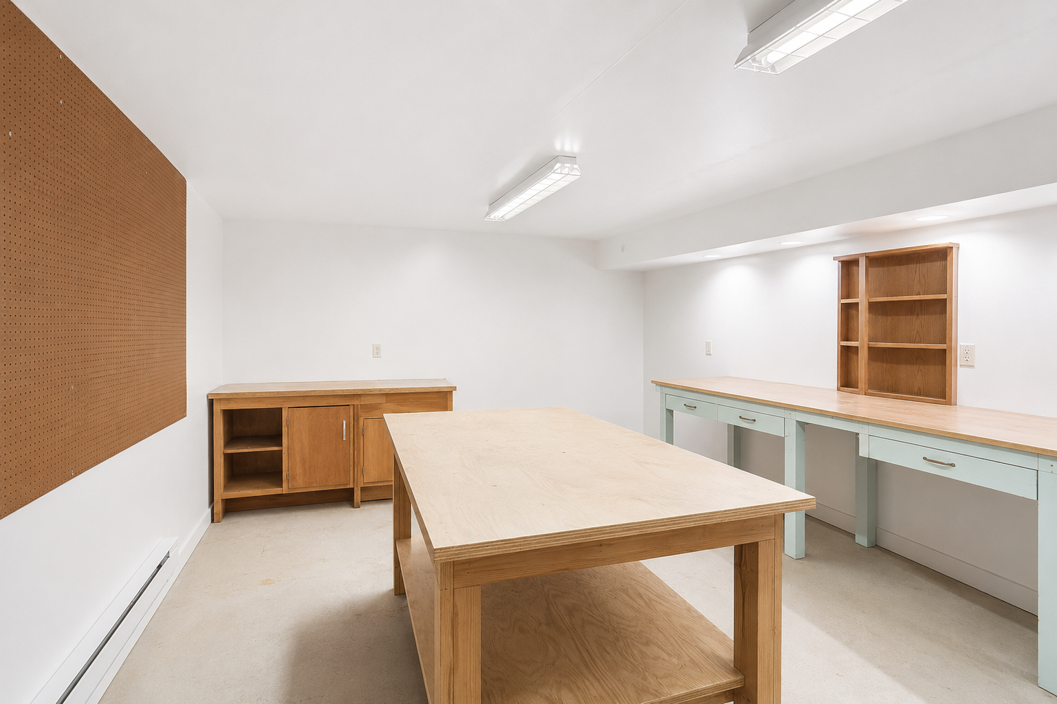 Spacious craft room or workshop area ideal for hobbies, projects, storage, or creative workspace needs.