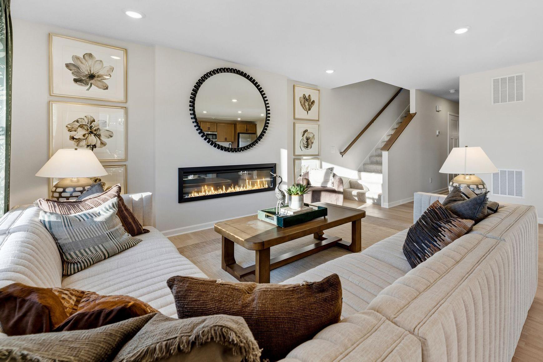 Sleek and sophisticated setting by your new contemporary electric fireplace featuring adjustable flame and rock colors with 2 heat settings! Photo for reference only. Style, color and collections will vary.