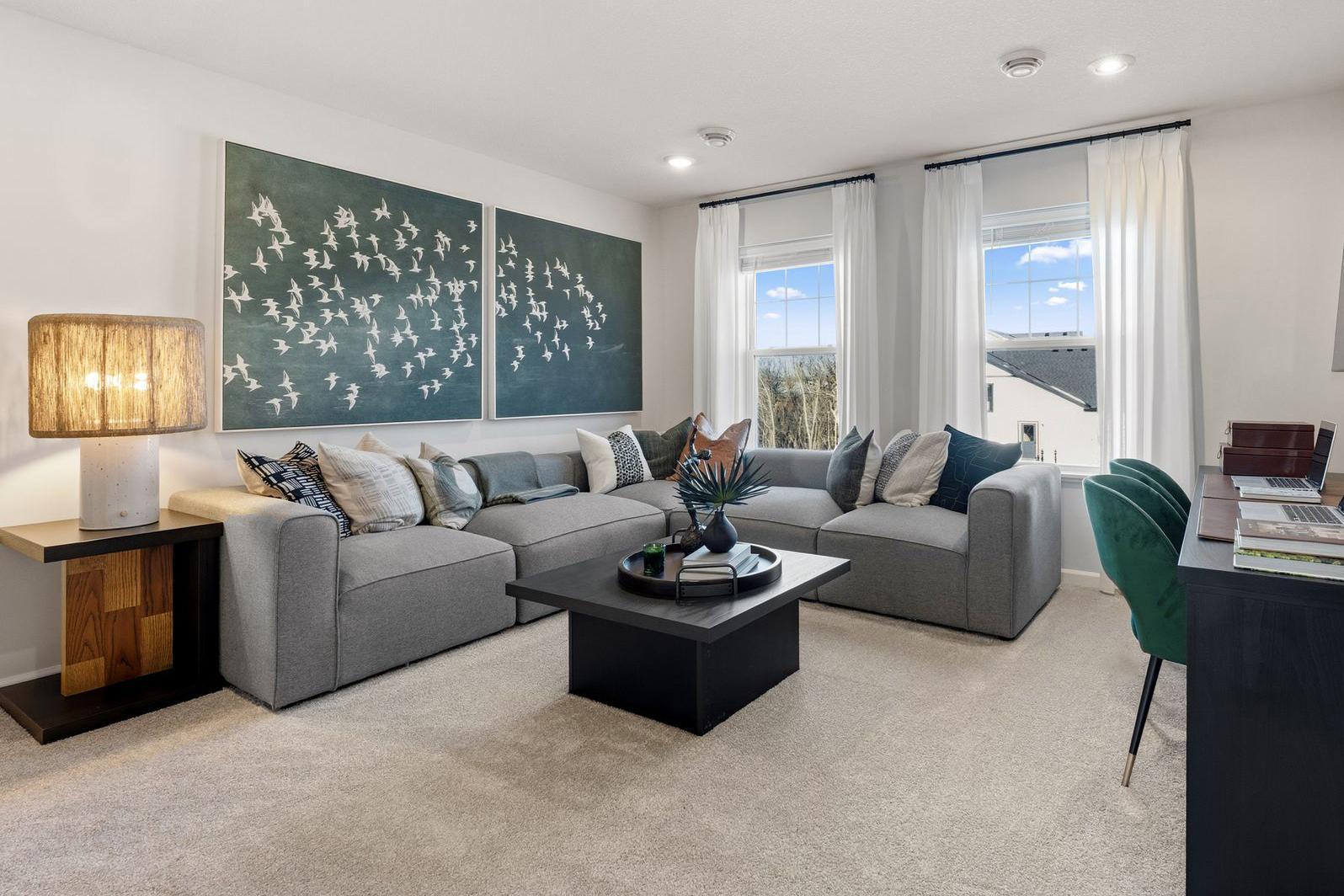 The sundrenched, spacious upper loft is a perfect secondary living space! Photo for reference only. Style, color and collections will vary.