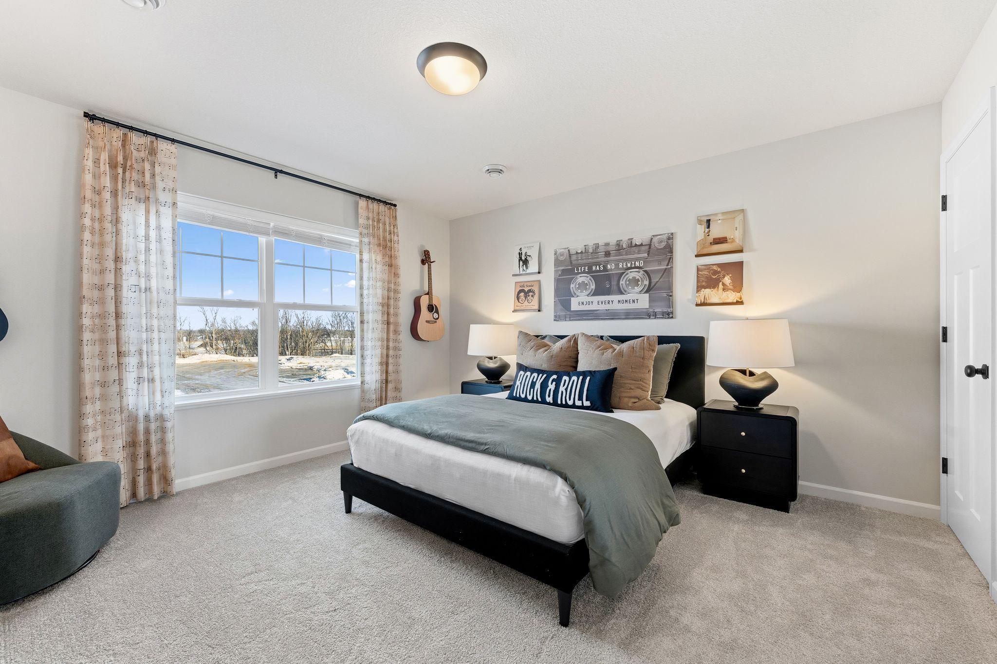 Spacious upper level bedroom 2 of 3. Ample closet space w/large windows and overhead light! Photo for reference only. Style, color and collections will vary.