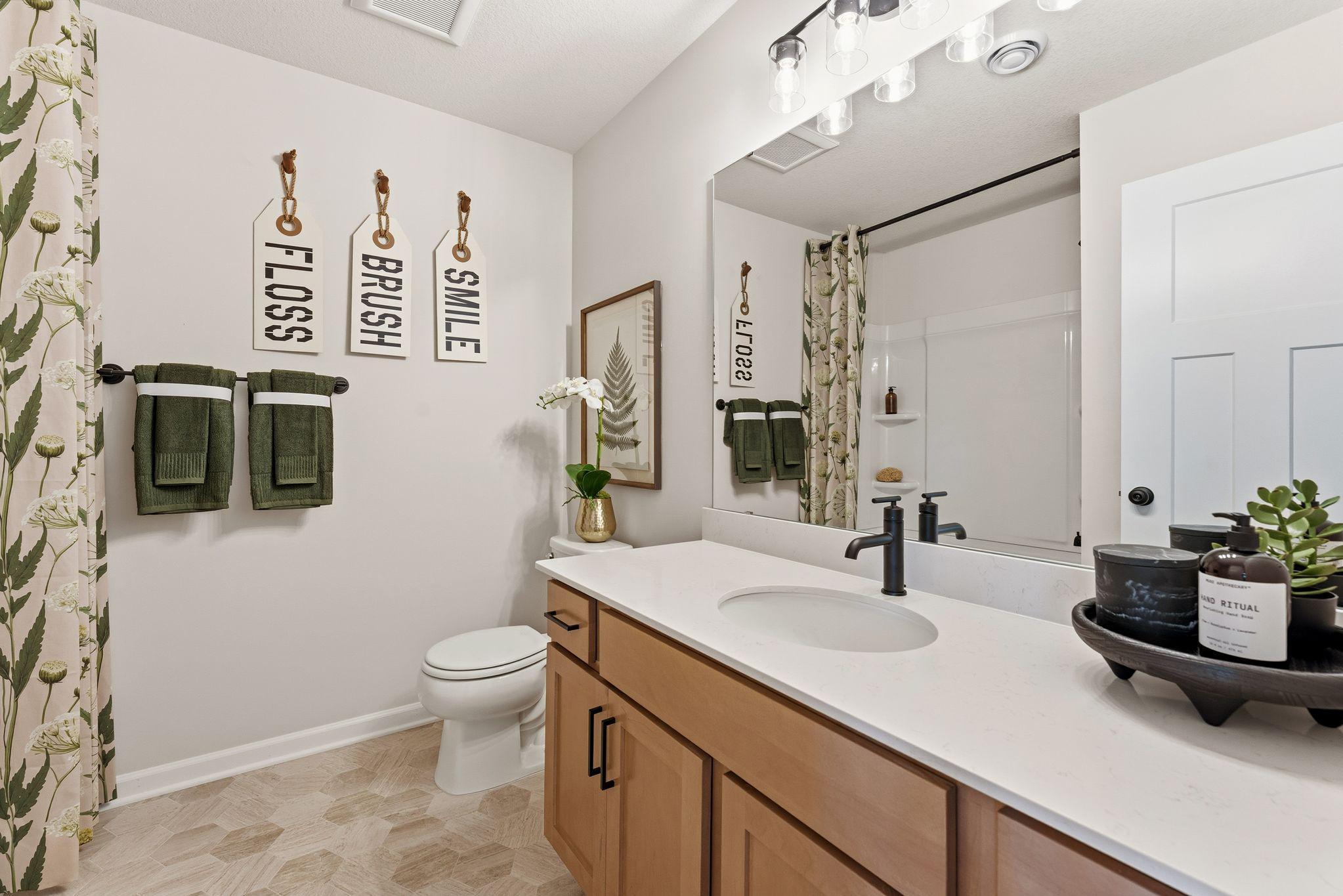 Upper level full bath perfectly located just steps from bedrooms 2 & 3! Photo for reference only. Style, color and collections will vary.