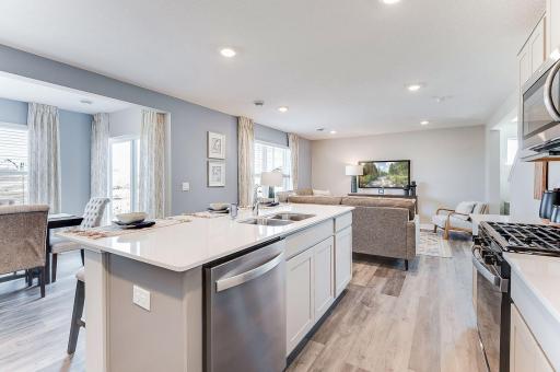 Enjoy a beautiful island with quartz countertops and barstool seating open to the dining room!