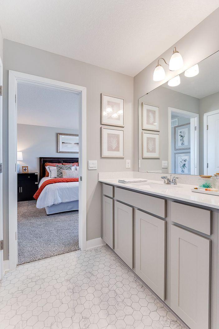 The private en suite bathroom features quartz countertops with a huge walk-in closet!