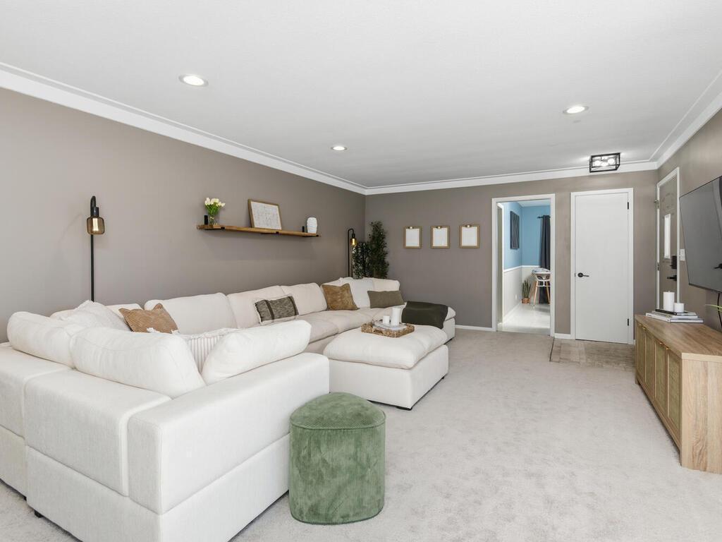 Modern recessed lighting and crown molding elevate the living space, seamlessly connecting to the rest of the main level.