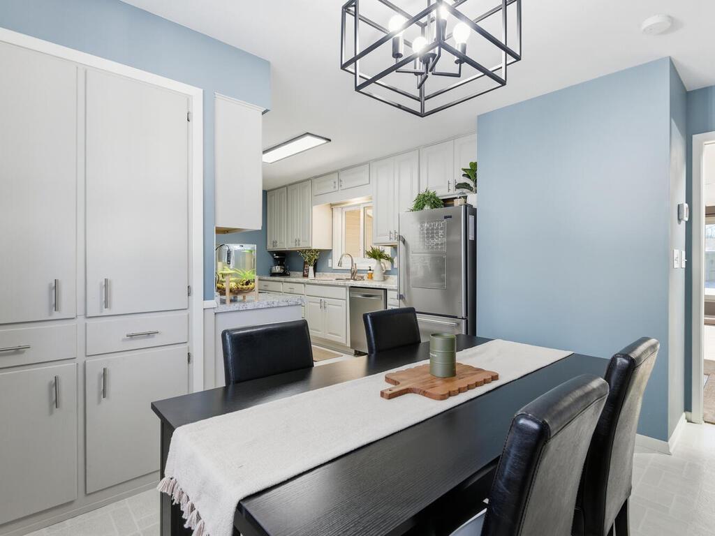 The updated kitchen flows into this comfortable dining space, offering great natural light and a view of the backyard.