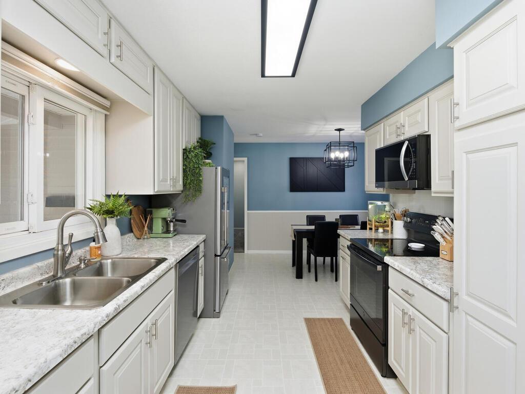 The kitchen features an efficient design with its open connection to the dining area.