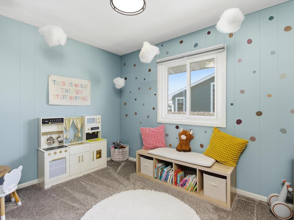 Bright and cheerful third bedroom featuring updated neutral carpet, fresh paint, and ample closet space.