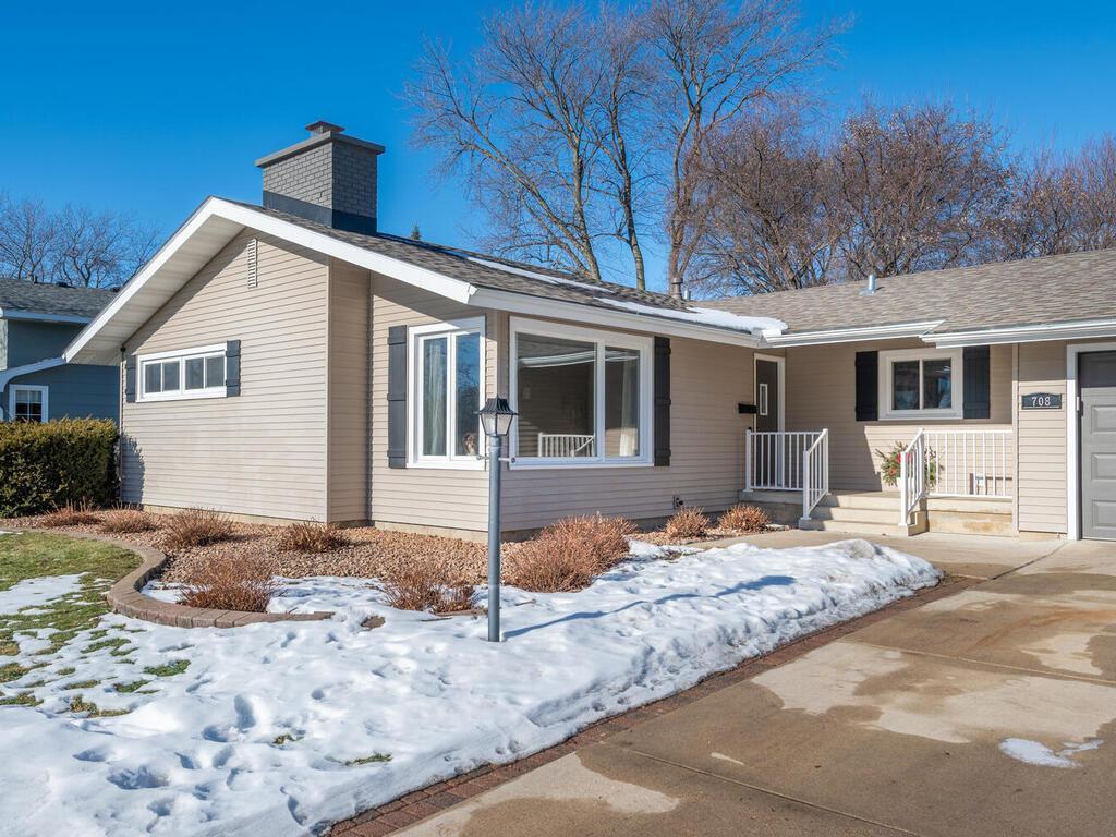 Front exterior with inviting entry, updated siding, and well-maintained landscaping.