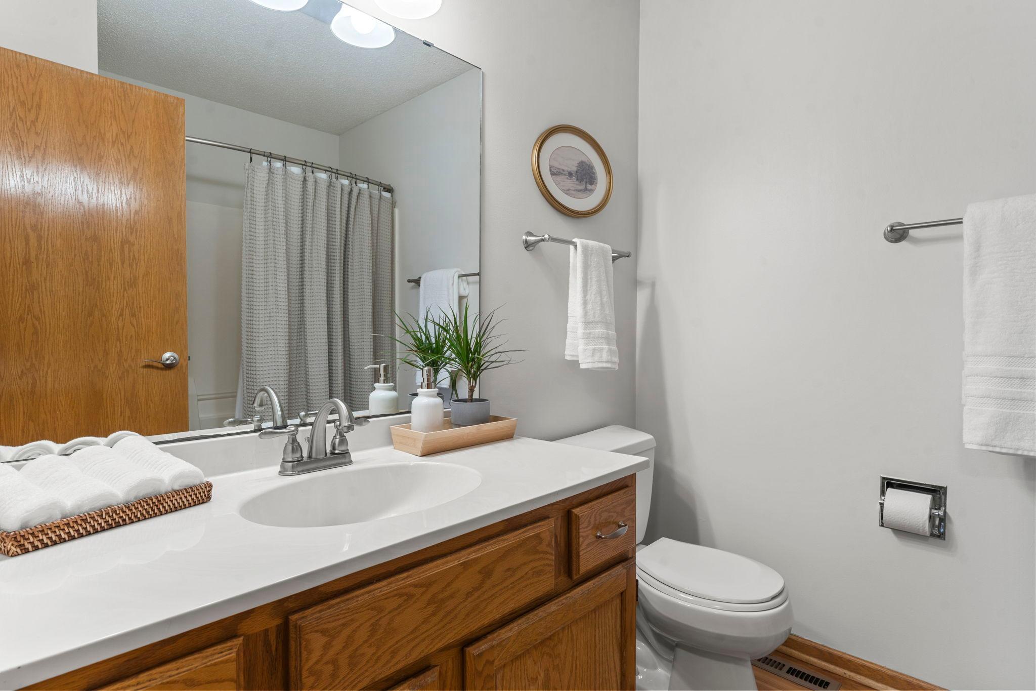 A shared full bathroom with a tub/shower combo and single vanity serves the upper level.