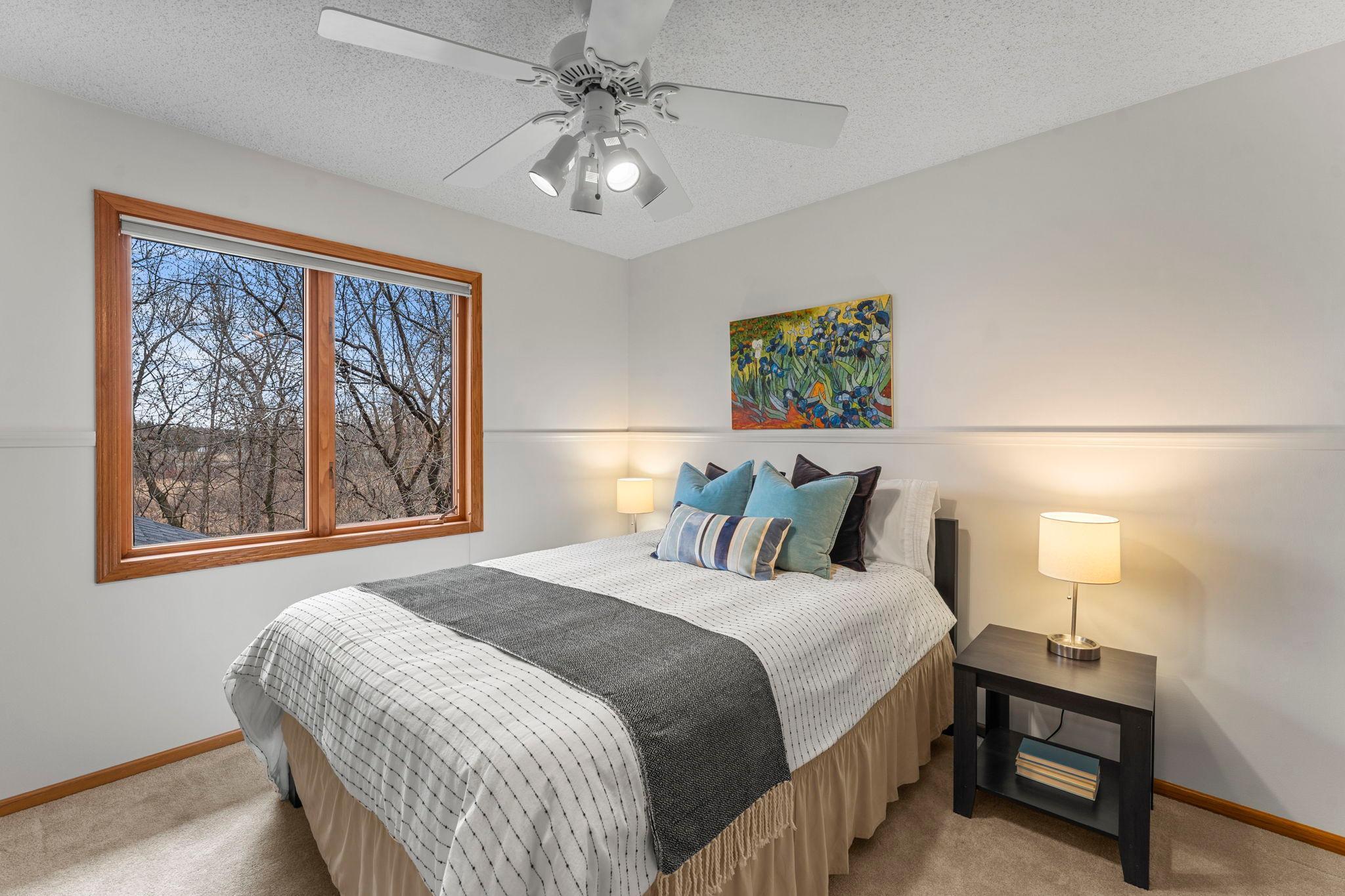 Bedroom three with carpeting, ceiling fan and ample closet space.