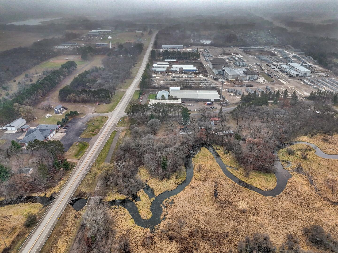See photo 1 for approximate lot lines. Photo is South facing with the North line of the lot being at the bottom of the photo to the right of Forest Blvd. The bridge & existing service road up to the bridge is part of the property.