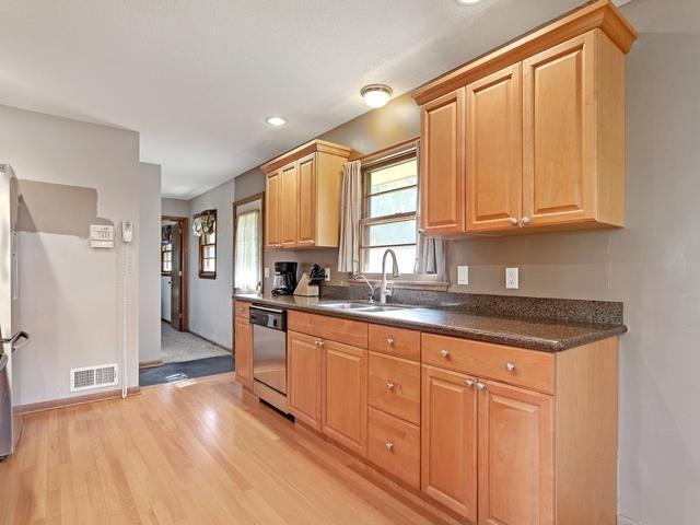Stylish updated kitchen complete with Corian countertops, quality cabinetry, and fresh flooring.