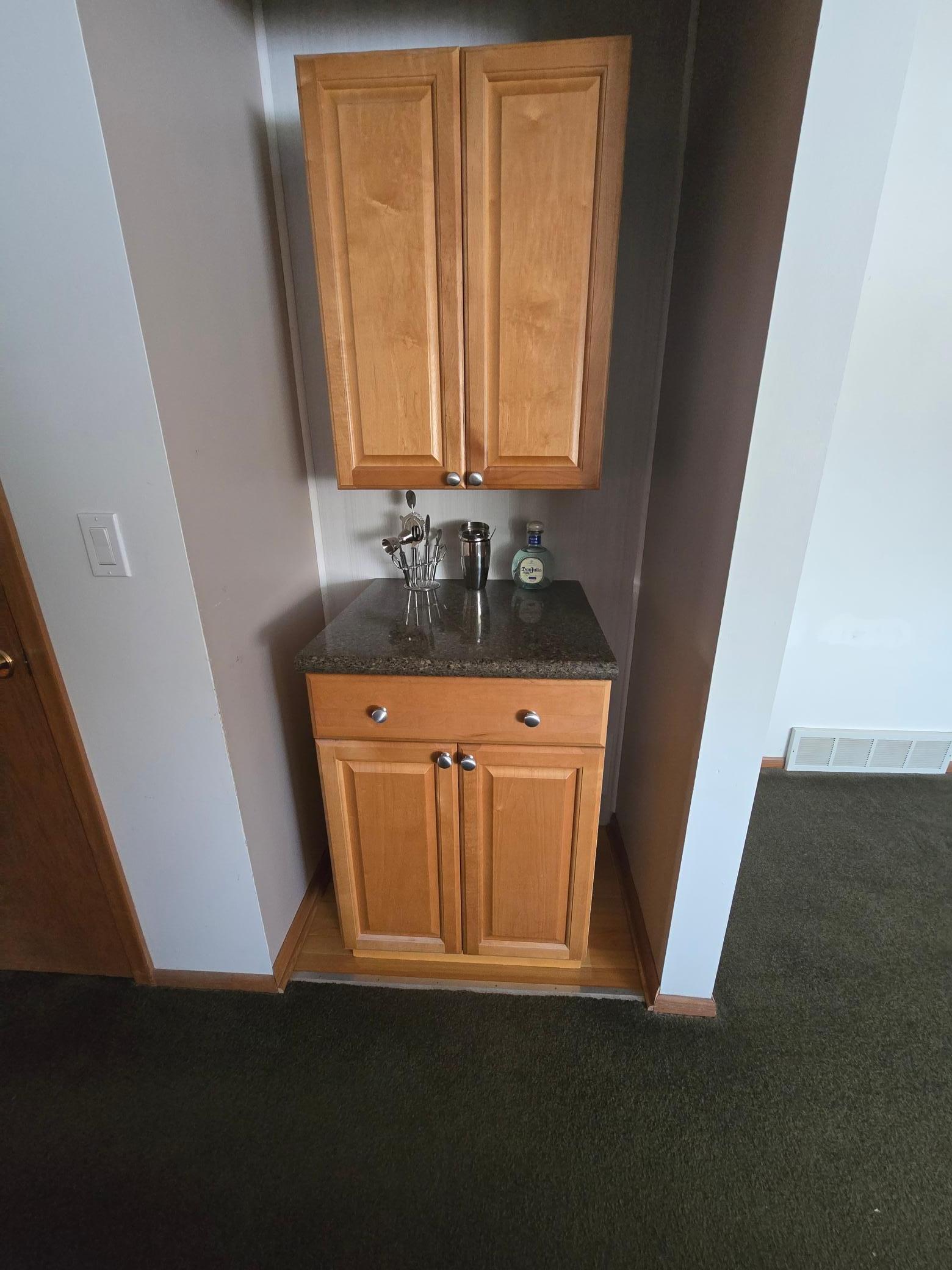 It is quite convenient to have a small dry bar in one's living room.