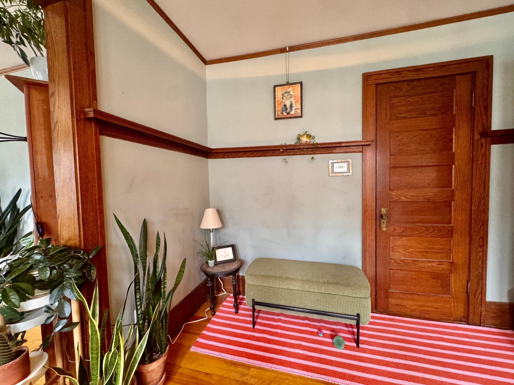 Unit 4 view of the beautiful original custom woodwork details and closet door.
