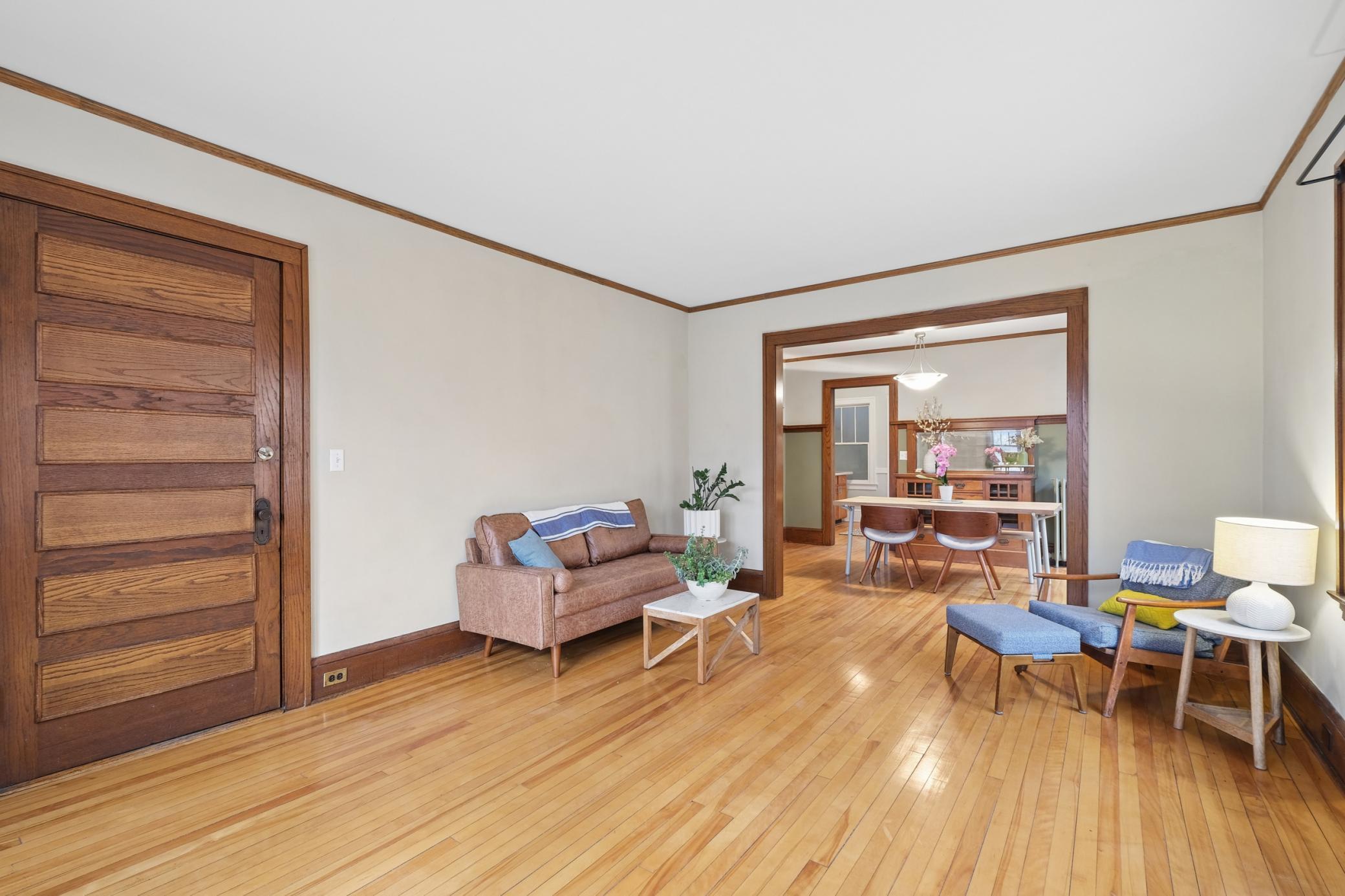 View of Unit 2's front door, spacious living room, and dinning room.