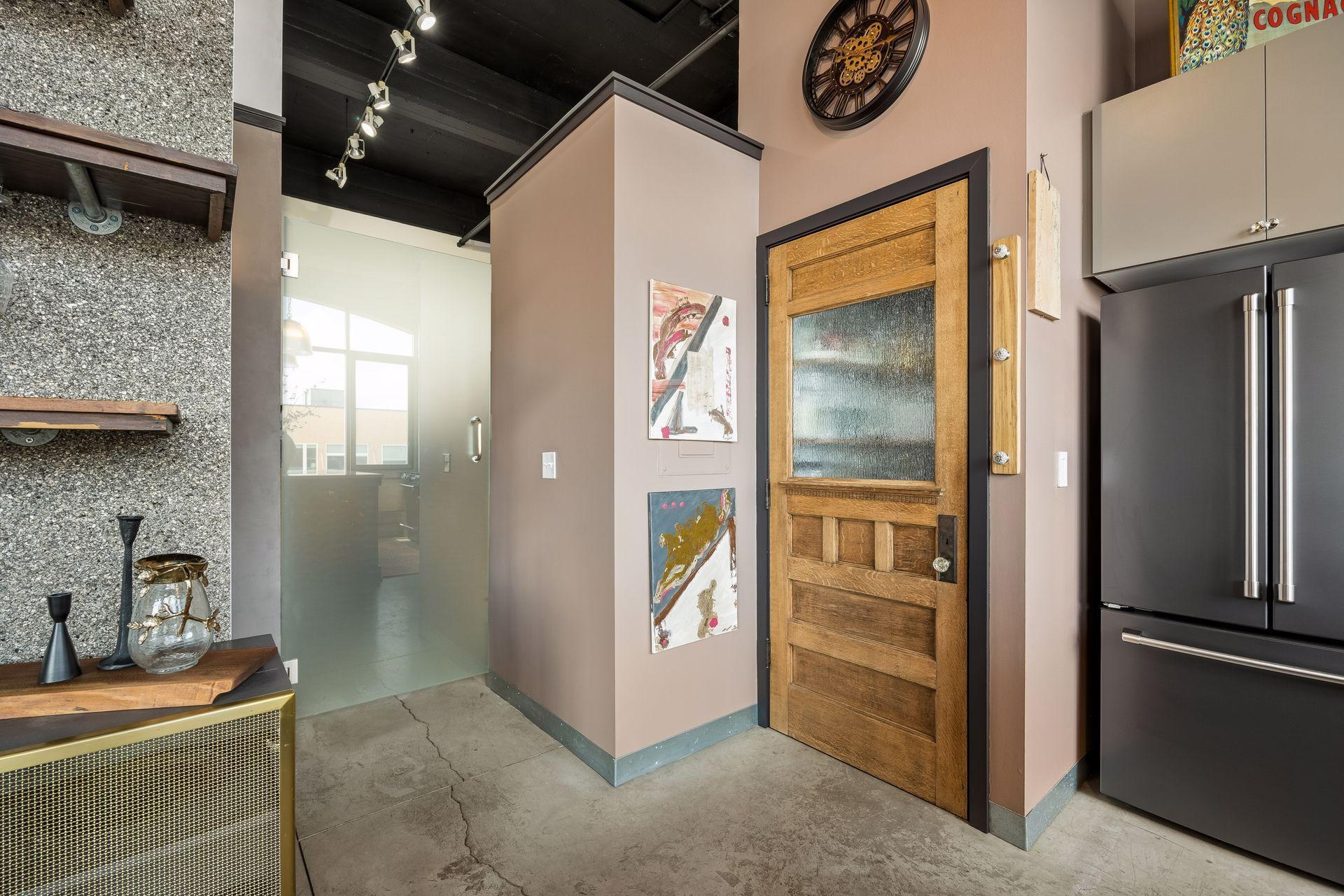 A frosted glass door encloses the second bedroom, offering privacy while allowing light to filter through.