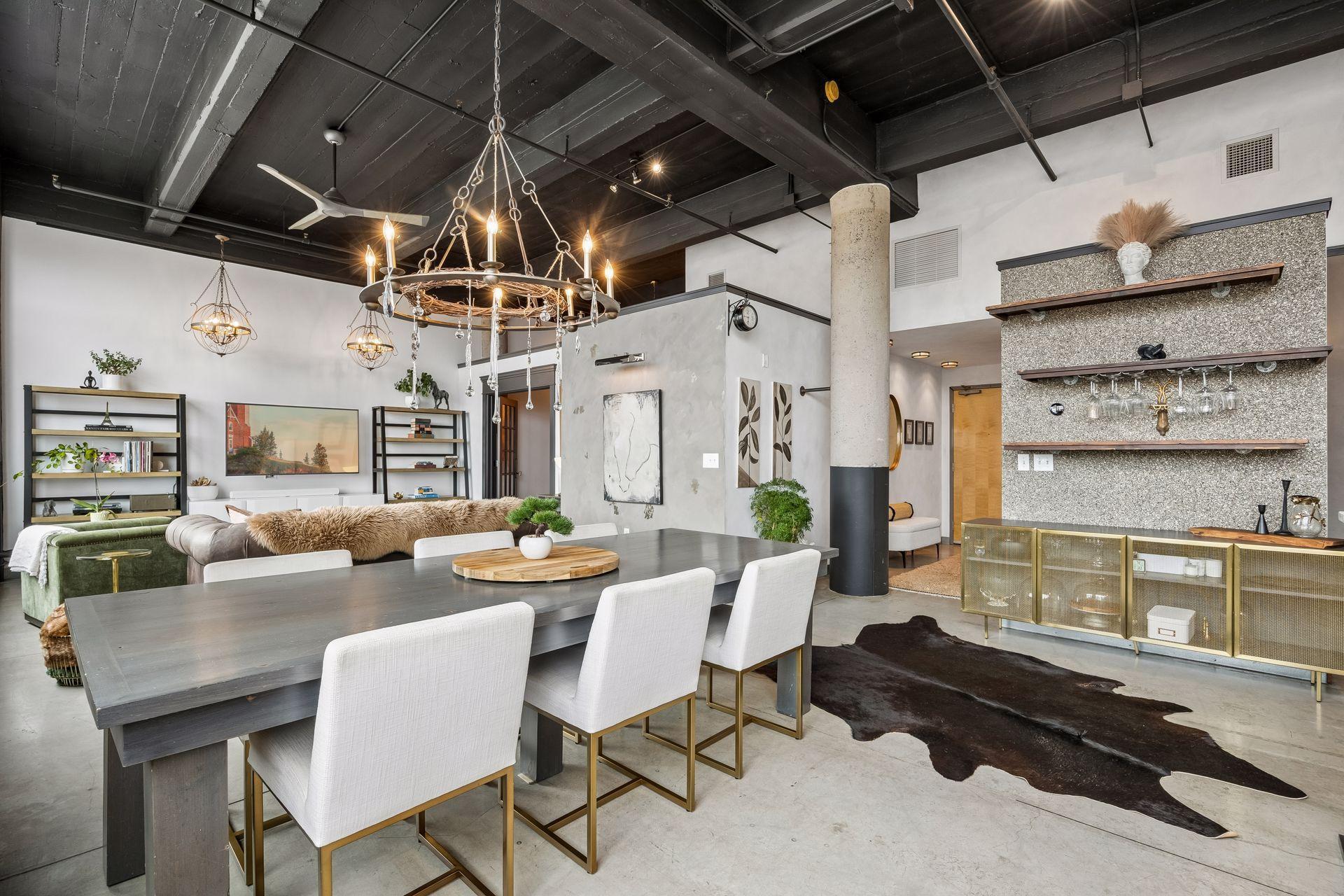 Soaring ceilings and concrete floors create a sense of volume, grounding the home in its industrial roots.