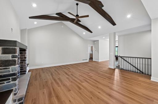 This spectacular Great Room captures the beauty of its wooded setting with soaring ceilings, oversized windows, and timeless architectural details.