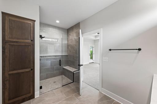 Everyday luxury awaits in this custom walk-in shower with elegant tile, sleek glass, and timeless finishes.