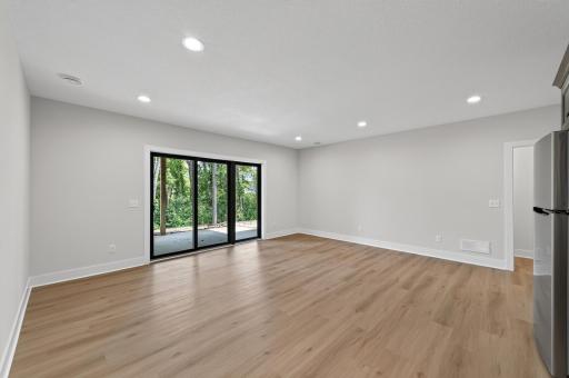 Relax or entertain in this spacious walkout family room overlooking a private wooded backdrop.