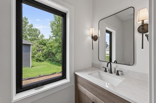 Stylish main-level powder room with designer finishes and abundant natural light.