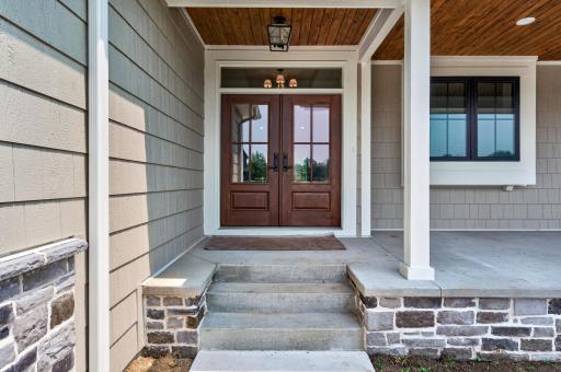 Timeless stonework, wood ceilings, and grand double doors create a stunning entrance you'll be proud to call home.