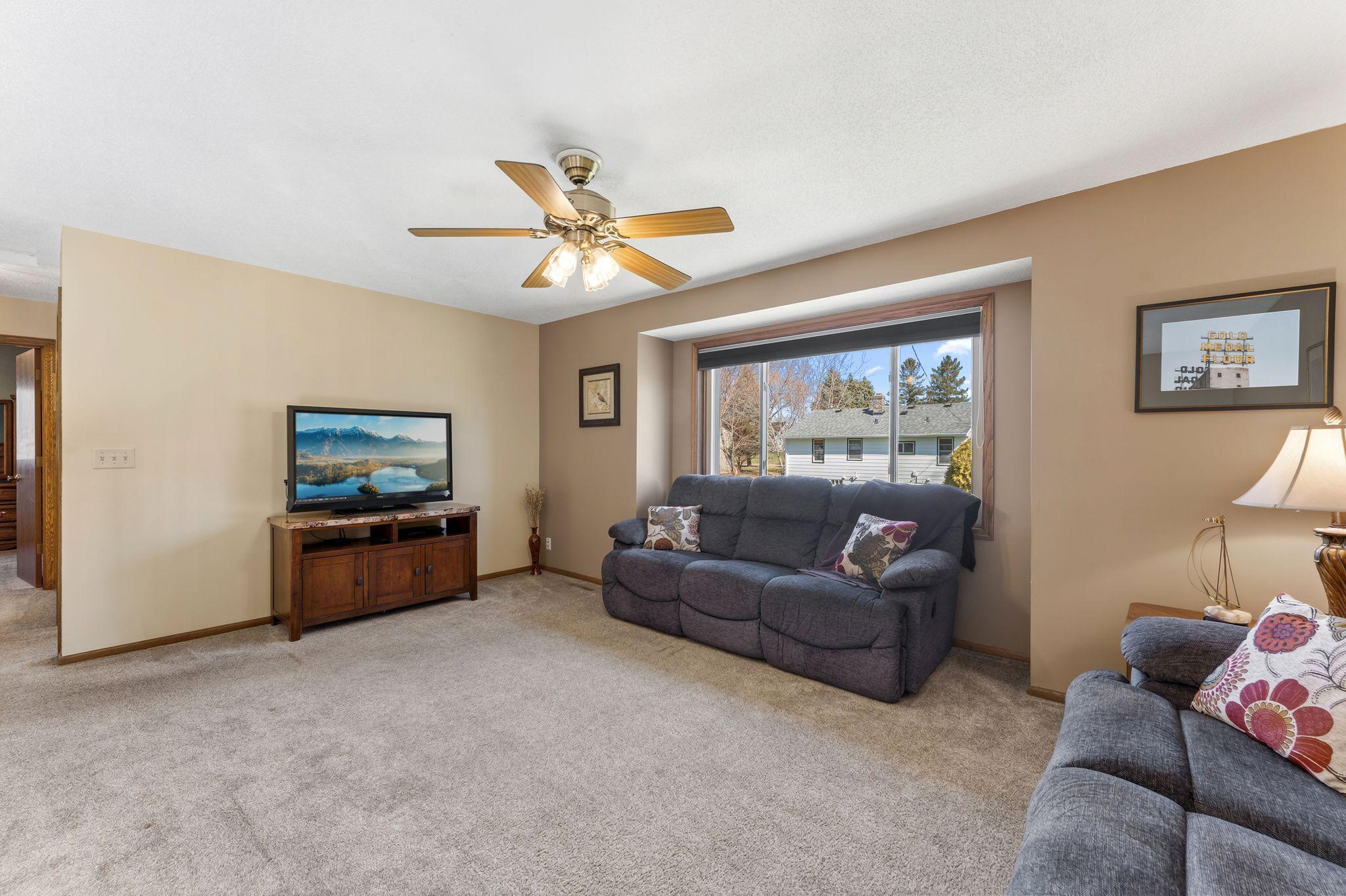 Living room with large window and views of backyard