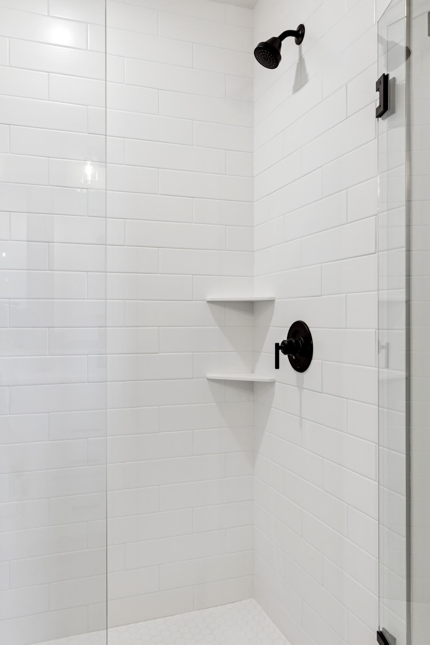 Generous walk in shower features modern fixtures, offering a sleek, spa-inspired design that feels both timeless and on-trend..jpg