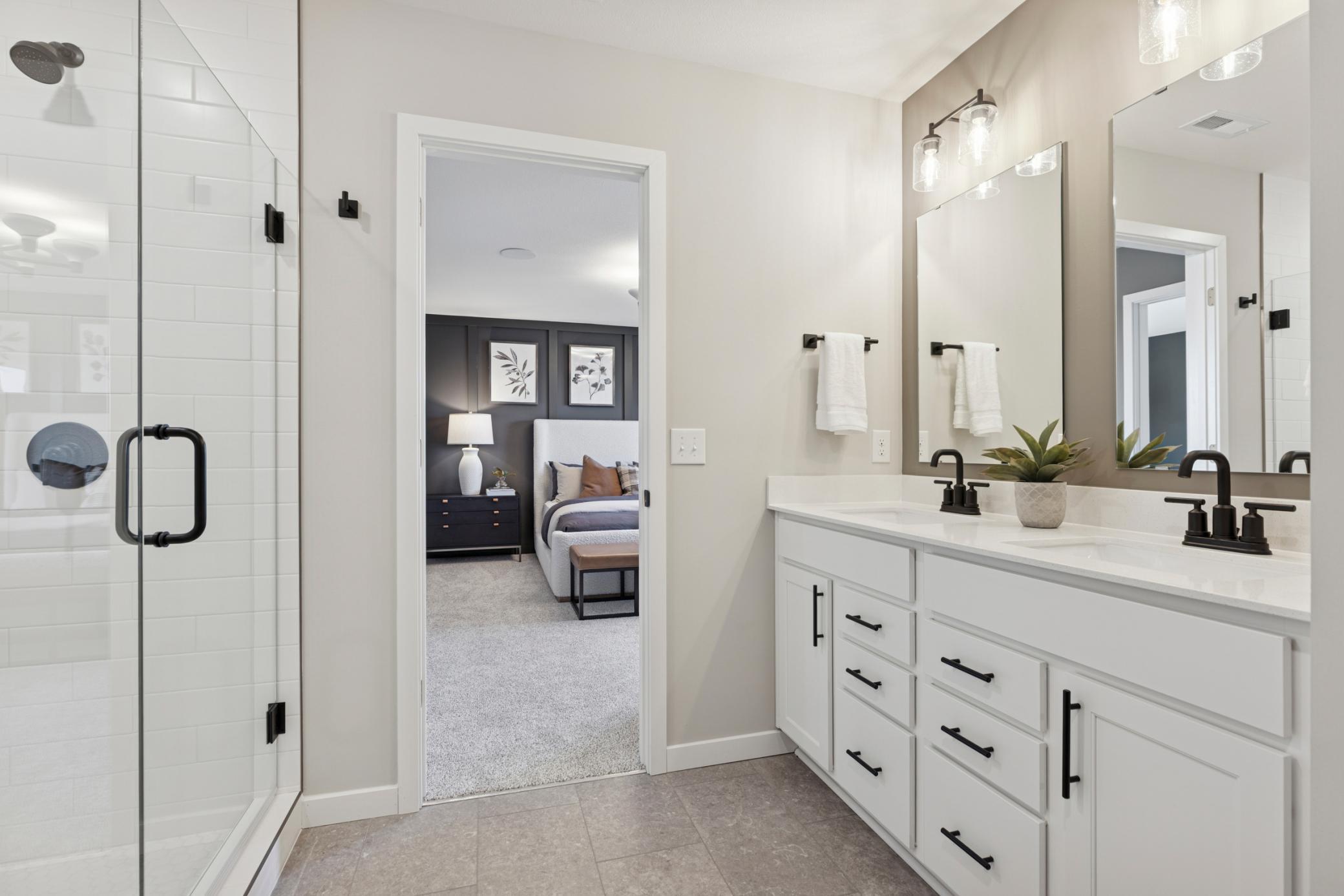 Double vanity with sleek countertops and ample storage provides both function and style—perfect for shared use while maintaining personal space..jpg