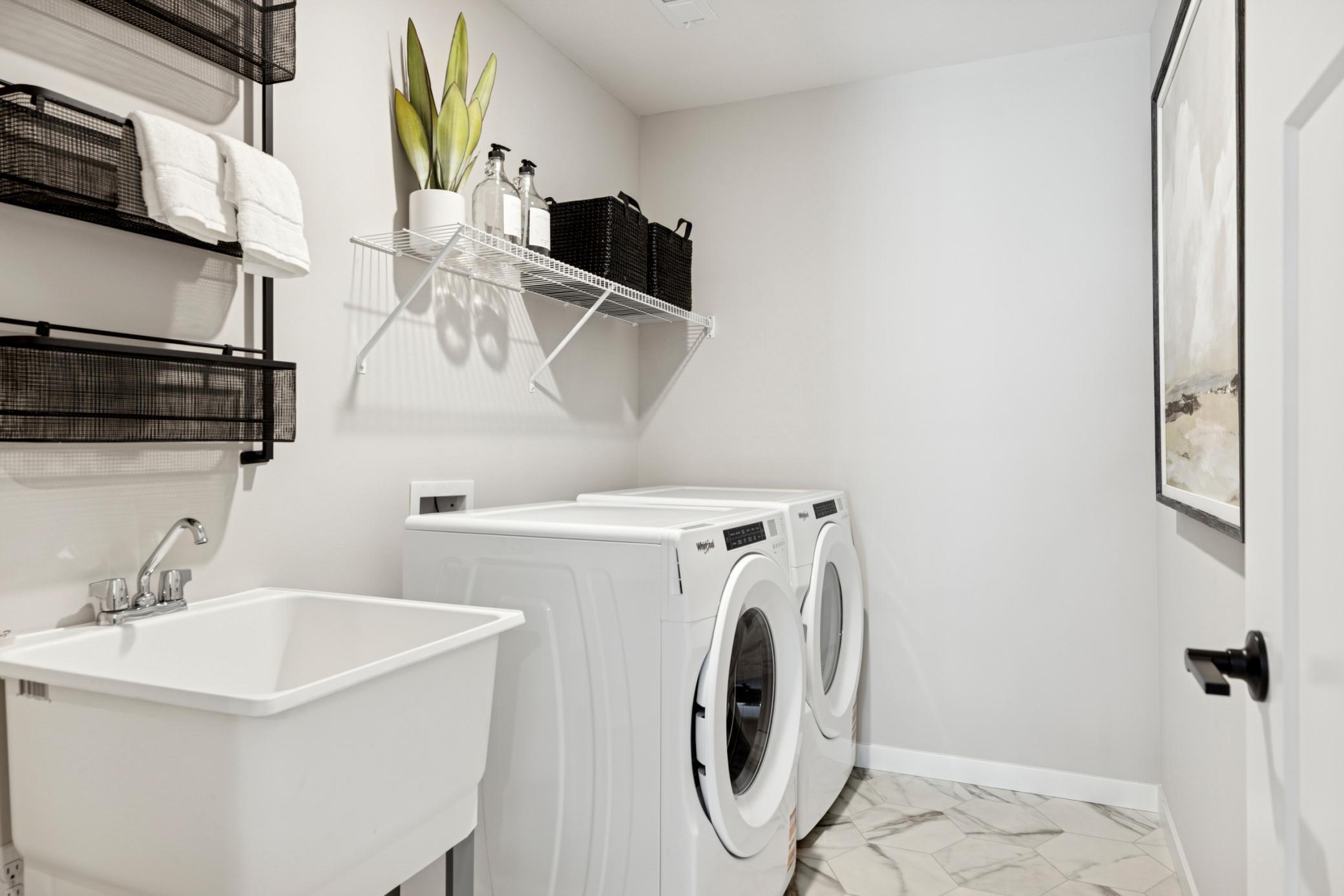 Spacious and well-organized upper-level laundry room designed for everyday ease, featuring ample space for folding, sorting, and storage..jpg