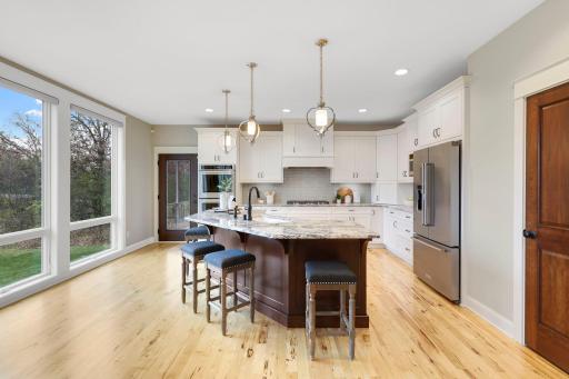 open kitchen with center island and floor to ceiling windows