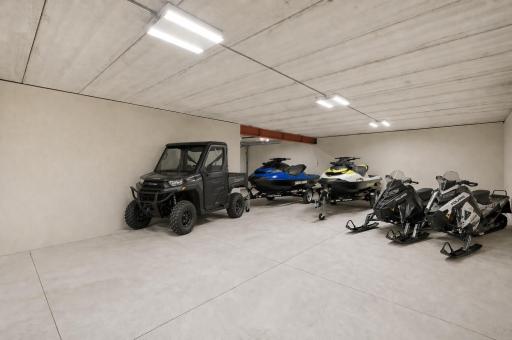 Lower level heated 3 car garage perfect for toys. Images are AI generated