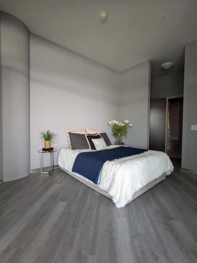 A bedroom that feels open, calm, and perfectly sized for a queen-bed lifestyle