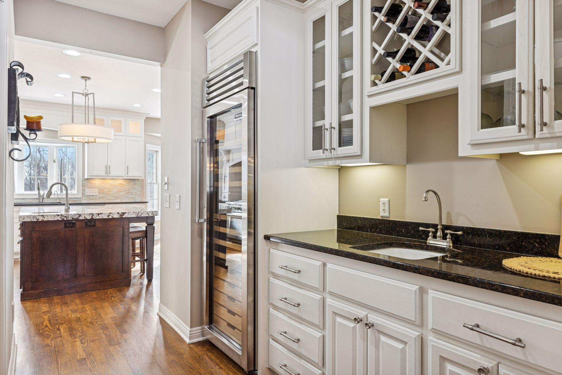 The butlers panty is conveniently located between the formal dining and the kitchen, and is complete with a wet bar, built-in, and full-size wine refrigerator