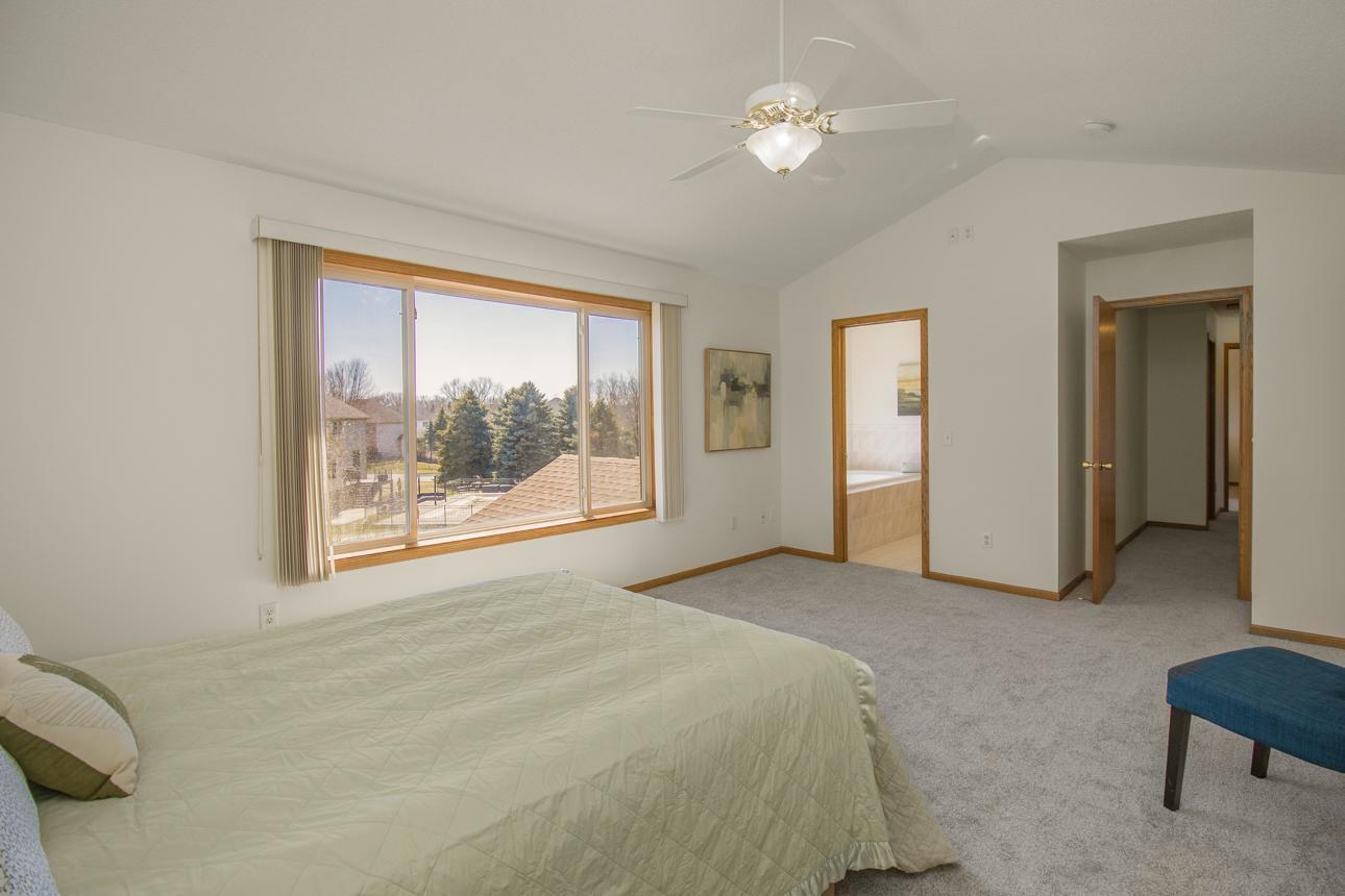 Primary bedroom with large walk-in closet and bathroom with double vanity