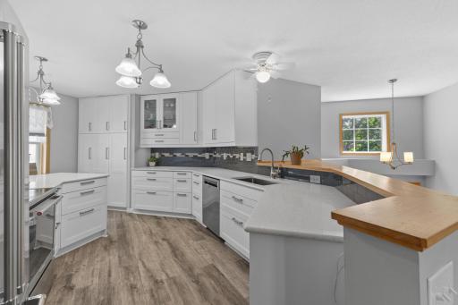 Enjoy all new custom cabinetry with soft close doors, designer glass tile backsplash w undercabinet lighting, quartz counters, LVP flooring & stainless appliances!