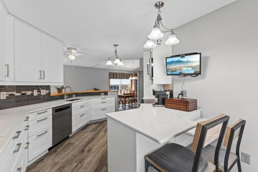 The well thought out kitchen design also includes a custom two tiered sitting area for added convenience!