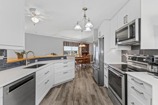 Updated lighting and custom cabinet hardware add the finishing touches to an incredibly stylish kitchen!