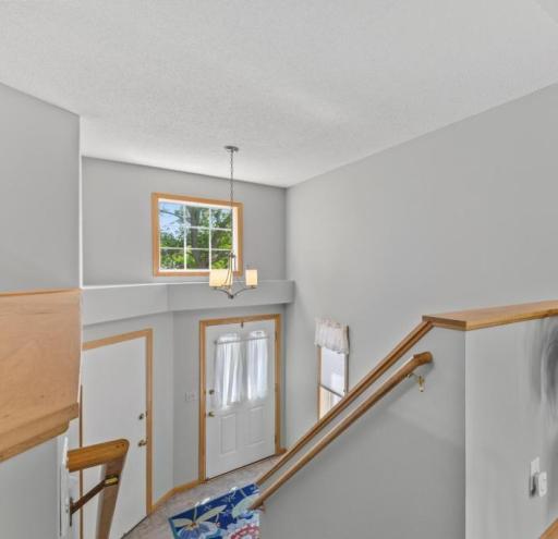 A sun filled entry with a large transom window and a soaring ceiling provides a welcoming feel the second you enter the home.