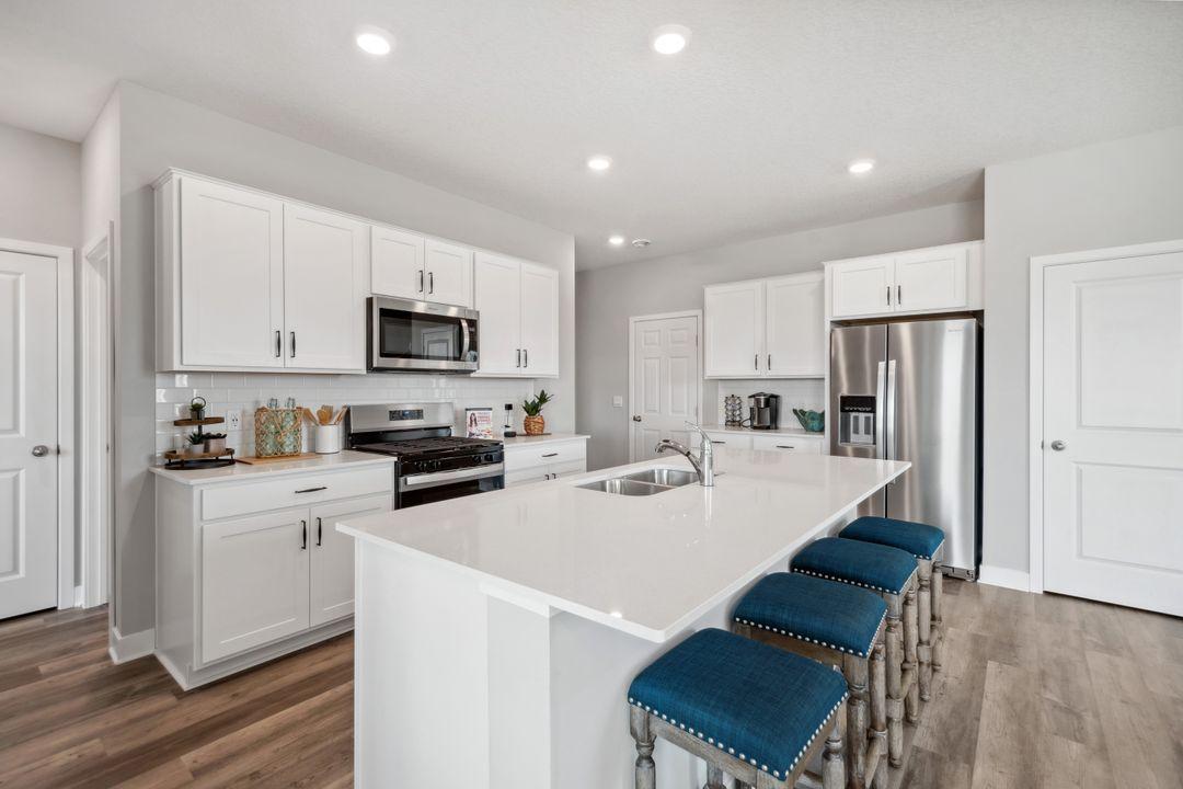 This beautiful kitchen has plenty of countertop and storage space! Photos are of a previously staged model.