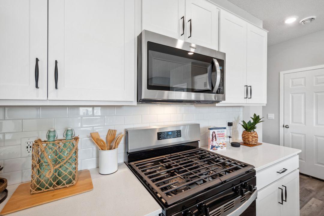 The tiled backsplash gives this kitchen a clean look while making it easy to keep clean.