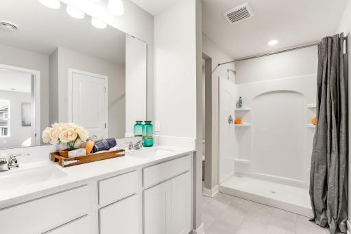 The primary bedroom has double sinks, then take refreshing shower!