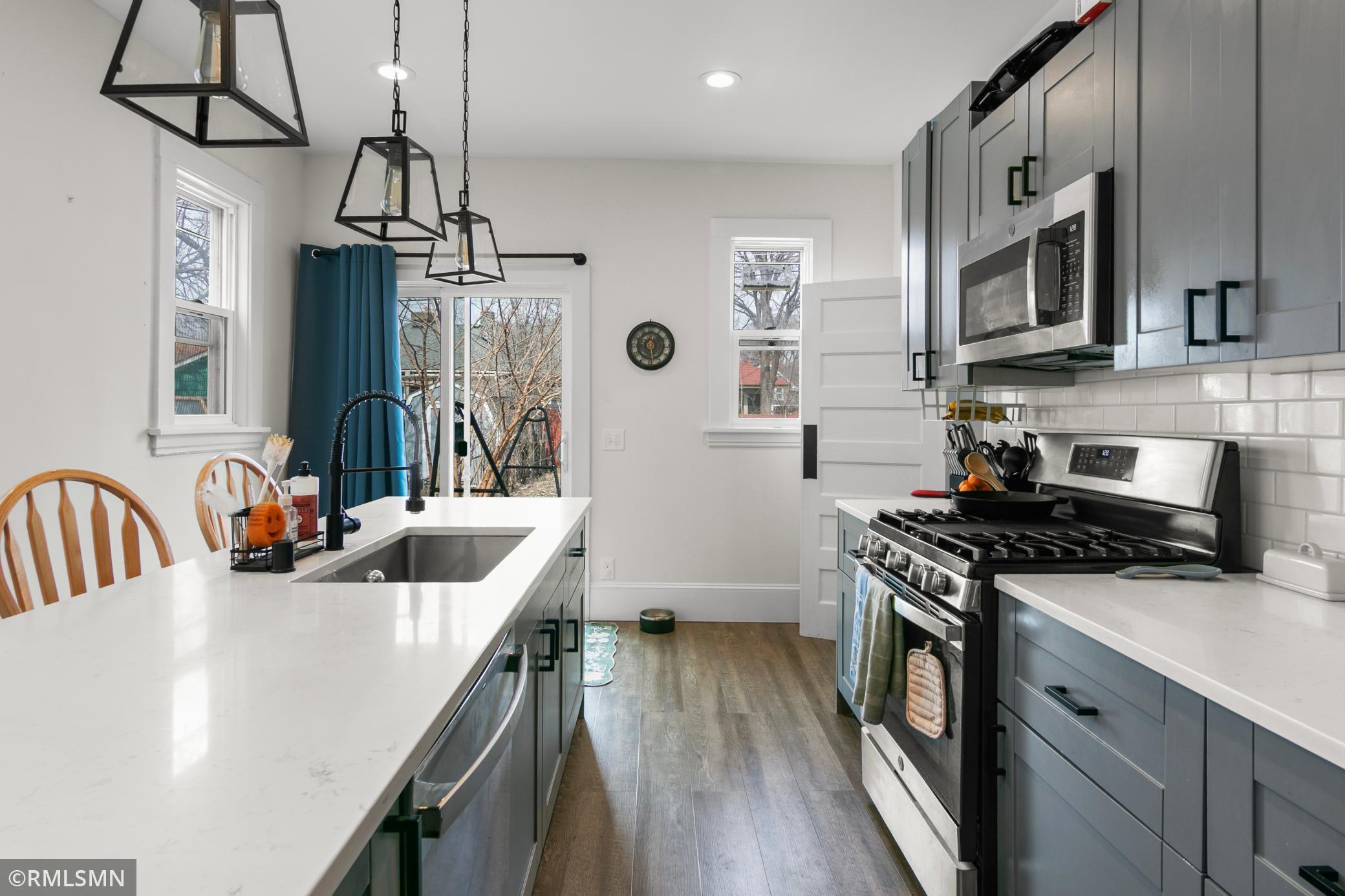 Kitchen facing the back yard, patio door and deck.