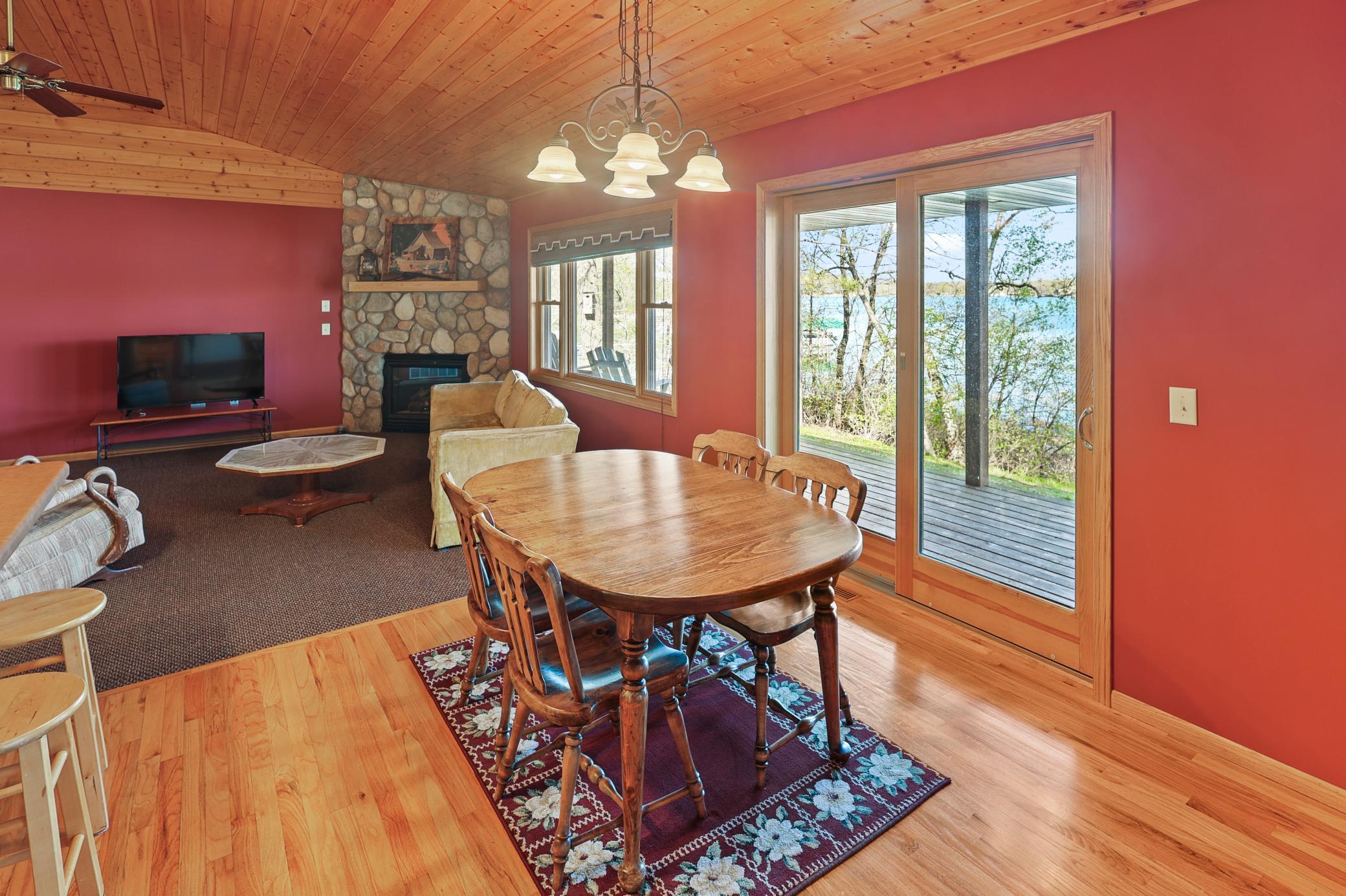 Dining area with wood floor and sliding doors to the covered porch.