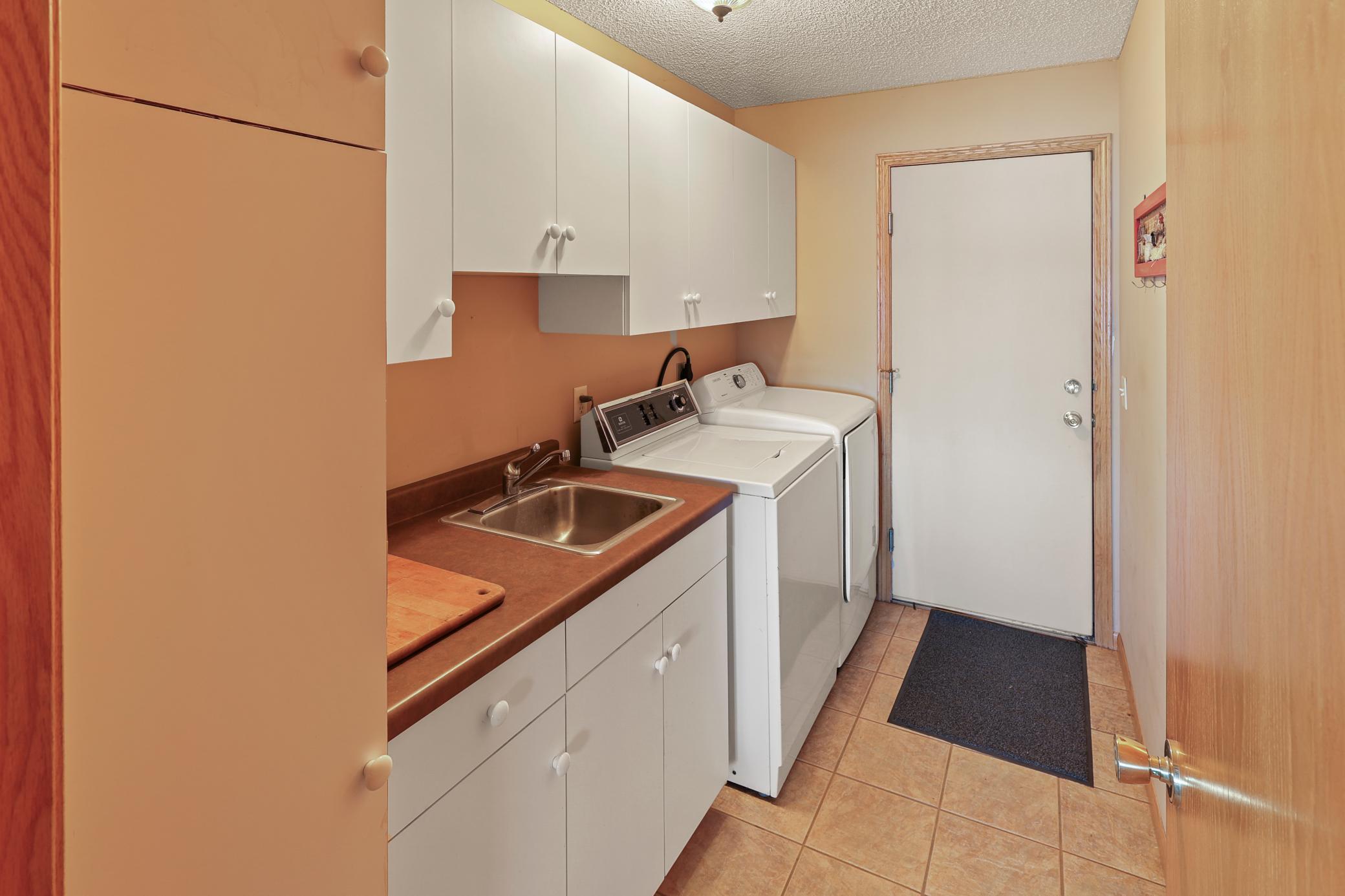 Main floor laundry room also leads to the attached double garage